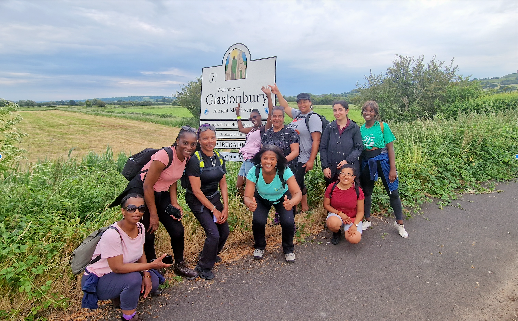 A group of female walkers in front of a sign